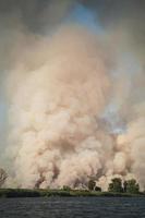 Large clouds of smoke, fire in nature. photo