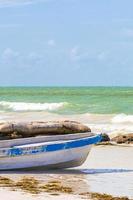 Beautiful Holbox island beach old blue boat turquoise water Mexico. photo