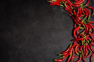 Bright red chilli pepper on a grey concrete background. Spicy food, ingredients photo