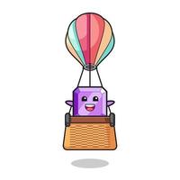 purple gemstone mascot riding a hot air balloon vector