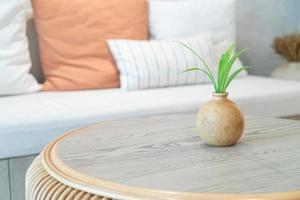 ceramic or porcelain vase with plant decoration on table in living room photo