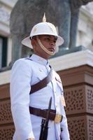BANGKOK THAILAND  APRIL 20 2016 A guard stands at attention in front of the Chakri Mahaprasat in the Grand Palace complex