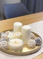 Candles on a tray with christmas winter decor photo