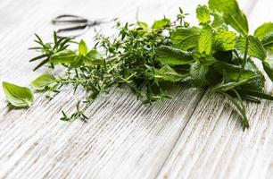 Fresh herbs cut in home garden, on wooden rustic table photo