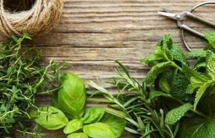 Fresh herbs  on wooden background top view photo