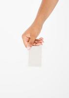 hand hold blank business card. female arm hold paper isolated on white background. copy space. mock up. photo