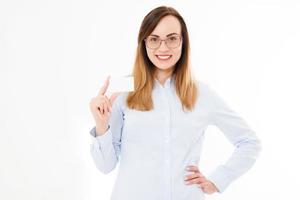 Young smiling woman holding a blank business card isolated on white background. Copy space photo