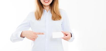 young woman in shirt holding business card isolated on a white background, female hand holding card. Business concept. Copy space photo