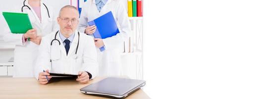 three doctors posing in the clinik medical office,copy space,billboard or banner photo