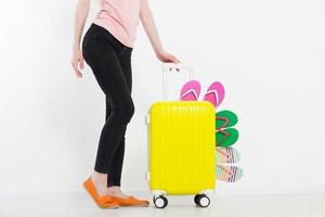 girl with suitcase isolated on white background .Summer holidays. summer flip flops or slippers. Travel valise or bag. Mock up. Copy space. Template. Blank.