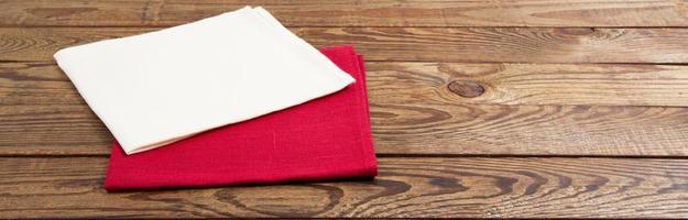 red and white napkin on wooden table background - mock up, copy space photo