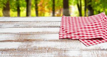 checkered red tablecloth on an empty table - top view photo