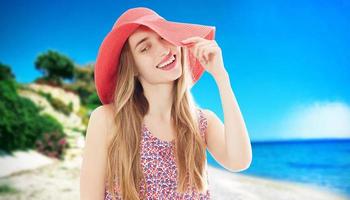Young happy woman on the beach in summer vacation photo