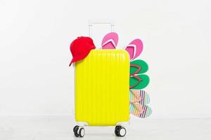 suitcase isolated on white background Summer holidays. summer flip flops or slippers.Sandals beach.Red cap.Travel valise or bag. Mock up. Copy space. Template. Blank. photo