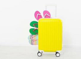 suitcase isolated on white background Summer holidays. summer flip flops or slippers.Sandals beach.Red cap.Travel valise or bag. Mock up. Copy space. Template. Blank. photo