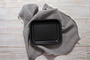 Black tray and tablecloth top view, empty board mockup photo