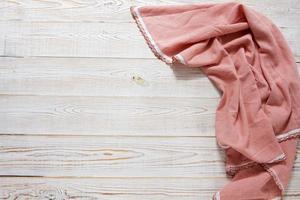 Kitchen table with folded towel. Top view with copy space photo