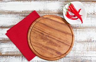 empty board and red hot pepper on an empty table photo