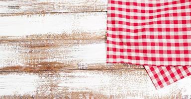 checkered red tablecloth on an empty table - top view photo