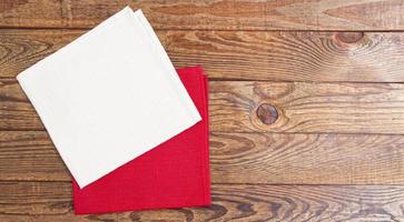 red and white napkin on wooden table background - mock up, copy space photo