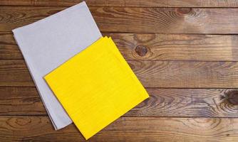 coloured napkins on empty wooden table - top view, copy space photo