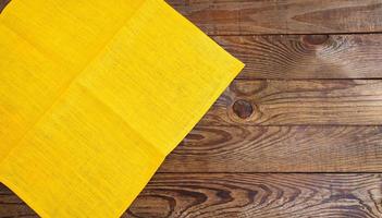 coloured napkins on empty wooden table - top view, copy space