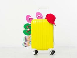 suitcase isolated on white background Summer holidays. summer flip flops or slippers.Sandals beach.Red cap.Travel valise or bag. Mock up. Copy space. Template. Blank. photo