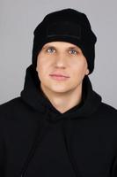 young man in black hat isolated, copy space photo