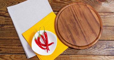 Napkin and board for pizza on wooden desk closeup, tablecloth. Canvas, dish towels on white wooden table background top view mock up. Selective focus photo