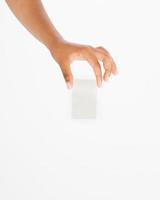 hand hold blank business card. female arm hold paper isolated on white background. copy space. mock up. photo