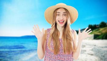 Friendly emotional beautiful girl in a summer hat on vacation on the beach of the sea. Maldives or Hawaii travel. photo