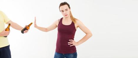 White woman refused alcohol beer bottles isolated on white background. Anti alcohol concept. Copy space. Anti female alcoholism, no bad habits concept. photo