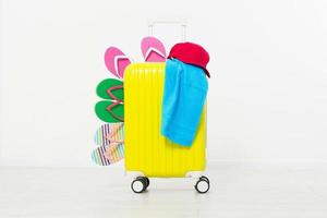 suitcase isolated on white background Summer holidays. summer flip flops or slippers.Sandals beach.Red cap.Travel valise or bag. Mock up. Copy space. Template. Blank. photo