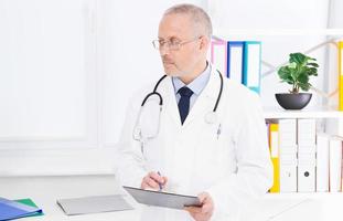 doctor is listening to something and looking away in the clinic office photo