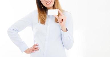 Young smiling woman holding a blank business card isolated on white background. Copy space photo