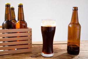 glass of beer on wooden table, top view. Beer bottles. Selective focus. Mock up. Copy space.Template. Blank. photo