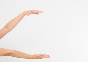 female hands measuring invisible items, woman's palm making gesture while showing small amount of something on white isolated background, side view, close-up, cutout, copy space photo