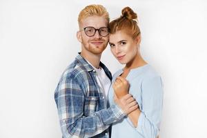 Beautiful young stylish happy couple love smiling embracing, man and woman smile looking at camera isolated onwhite background photo