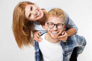 Portrait of a beautiful young happy smiling elegant couple - isolated mock up, background people.B eautiful young happy couple love smiling embracing, man and woman smile looking at camera photo