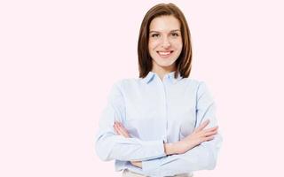 image of pretty smile brunette woman standing with arms crossed on pink background photo