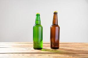 Beer bottles on a wooden table . Top view. Selective focus. Mock up. Copy space.Template. Blank. photo