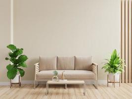 Mockup living room interior with sofa on empty cream color wall background.