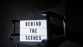 Director chair with behind the scene banner light box. photo