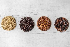 A collage of coffee beans showing various stages of roasting from green beans through to roast photo