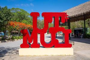 Multi colored Tulum text sign in the city on a bright sunny day photo