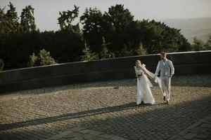 Young newlywed couple walking in the park photo