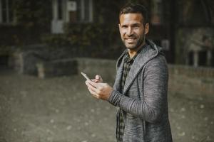 Young man using mobile phone in the park photo