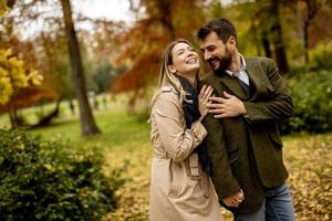 Young couple walking in the autumn park photo