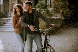 pareja joven, ambulante, con, bicicleta, en, otoño, parque foto