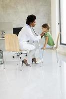 Cute little girl at the pediatrician examination photo